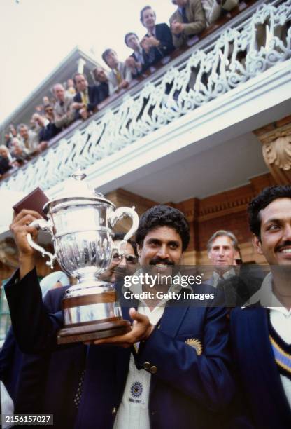 India all rounder Kapil Dev holds aloft the trophy on the balcony after the 1983 Cricket World Cup final Match between India and West Indies at Lords...