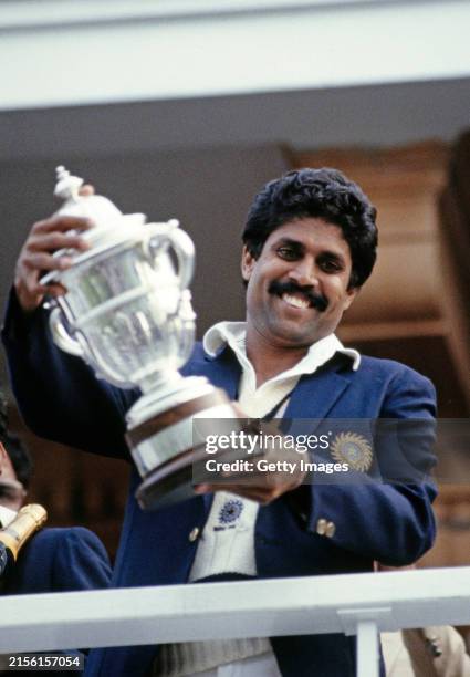 India all rounder Kapil Dev holds aloft the trophy on the balcony after the 1983 Cricket World Cup final Match between India and West Indies at Lords...