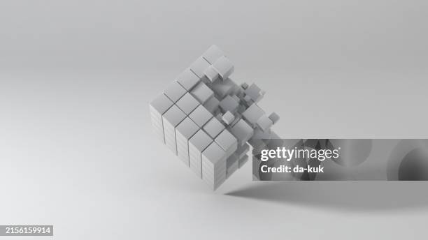 abstract 3d background. cube divides at small blocks and rotates against light grey background with shallow depth of field and copy space. representing big data and technology processes - mini split stock pictures, royalty-free photos & images