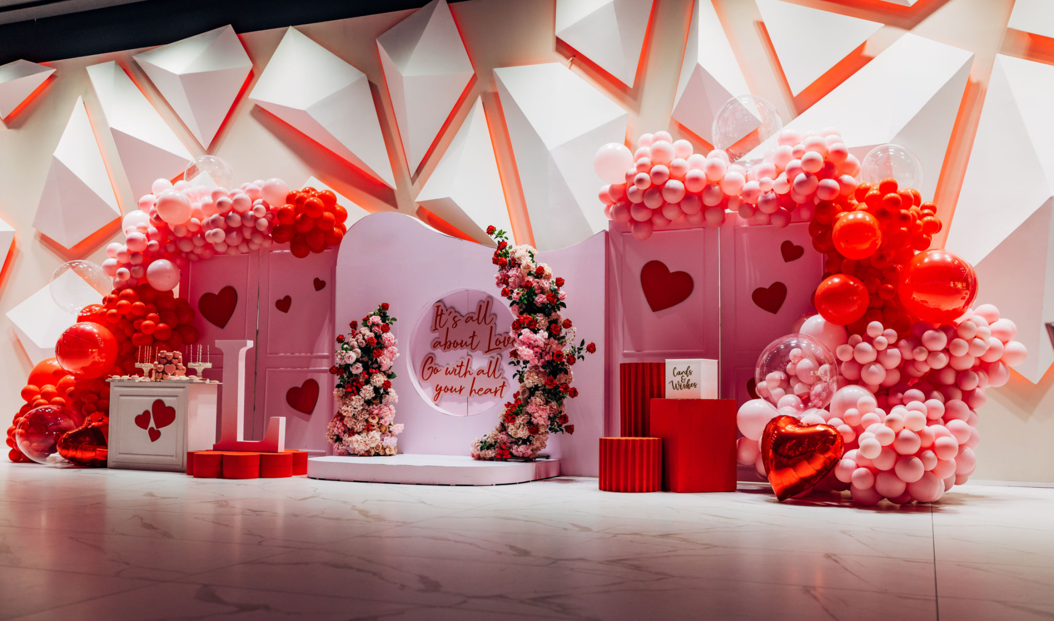 Arch decorated with red and pink balloons, flower arrangements. Photo wall decoration Arch decorated with red and pink balloons, flower arrangements. Photo wall decoration