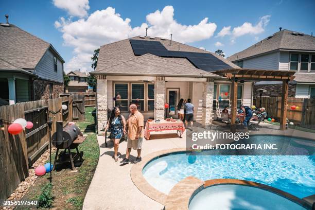 mexican american family having a party in backyard of sustainable home - establishing shot stock pictures, royalty-free photos & images