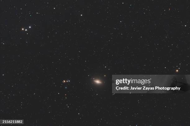 messier 104 and surroundings (sombrero galaxy) - spiral galaxy in corvus - sombrero galaxy stock pictures, royalty-free photos & images