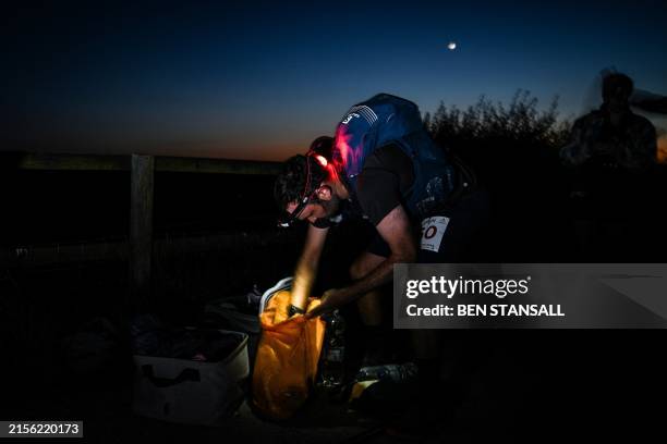 Runner Guy Shepherd stops at a crew point at mile 69 as he competes in the Centurion South Downs Way 100 ultramarathon, at Clayton Windmills near...