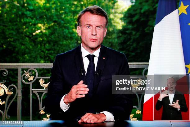 This screen shot shows France's President Emmanuel Macron speaking during a televised address to the nation during which he announced he is...