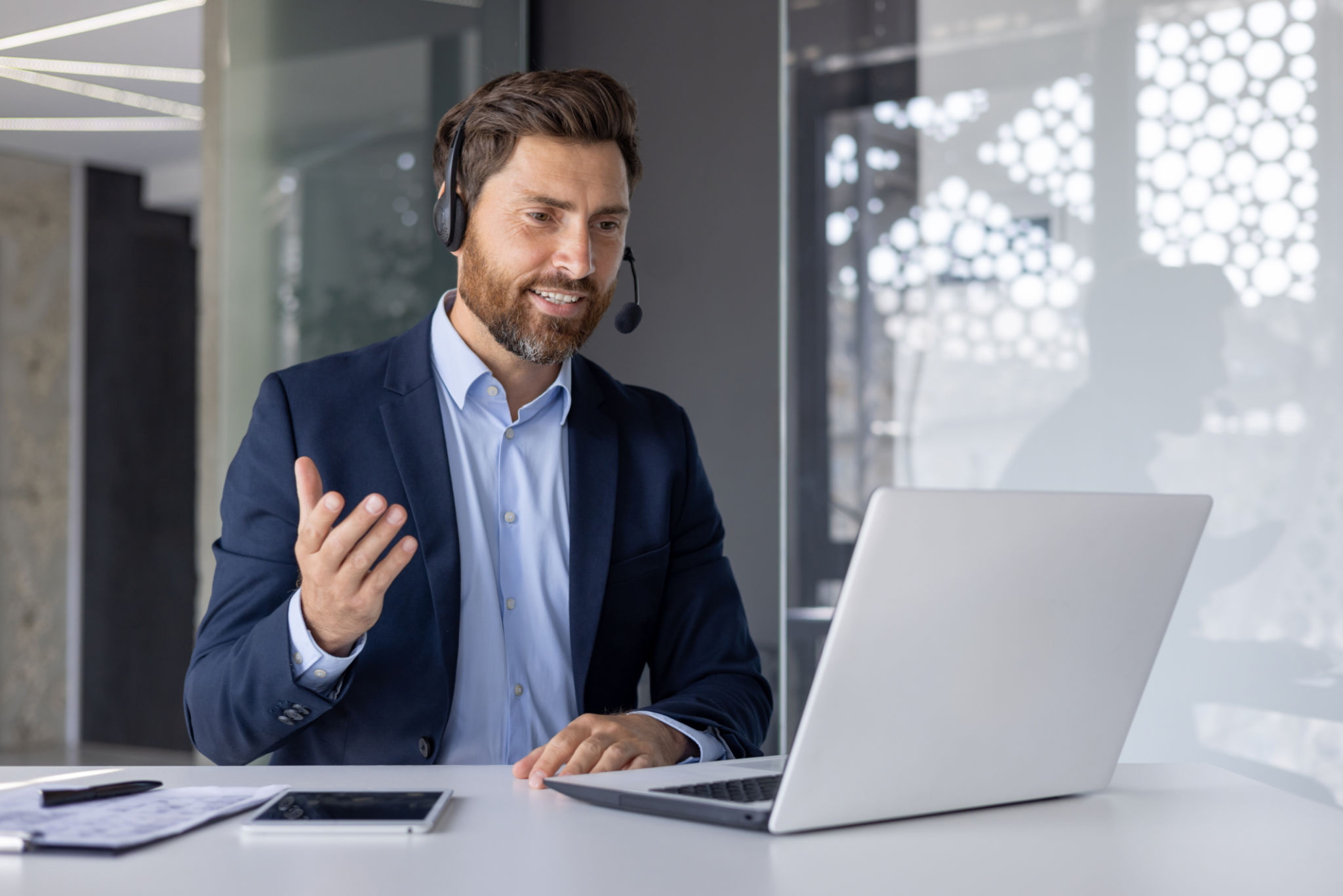 Confident businessman giving online presentation from office Confident businessman giving online presentation from office