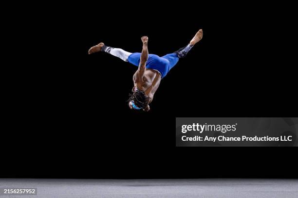 male gymnast in mid-air doing the splits up side down. - acrobatic activity stock pictures, royalty-free photos & images