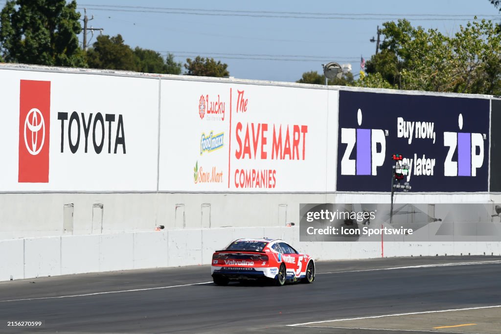 Kyle Larson drives under the Toyota, Save Mart, and Zip billboards as ...
