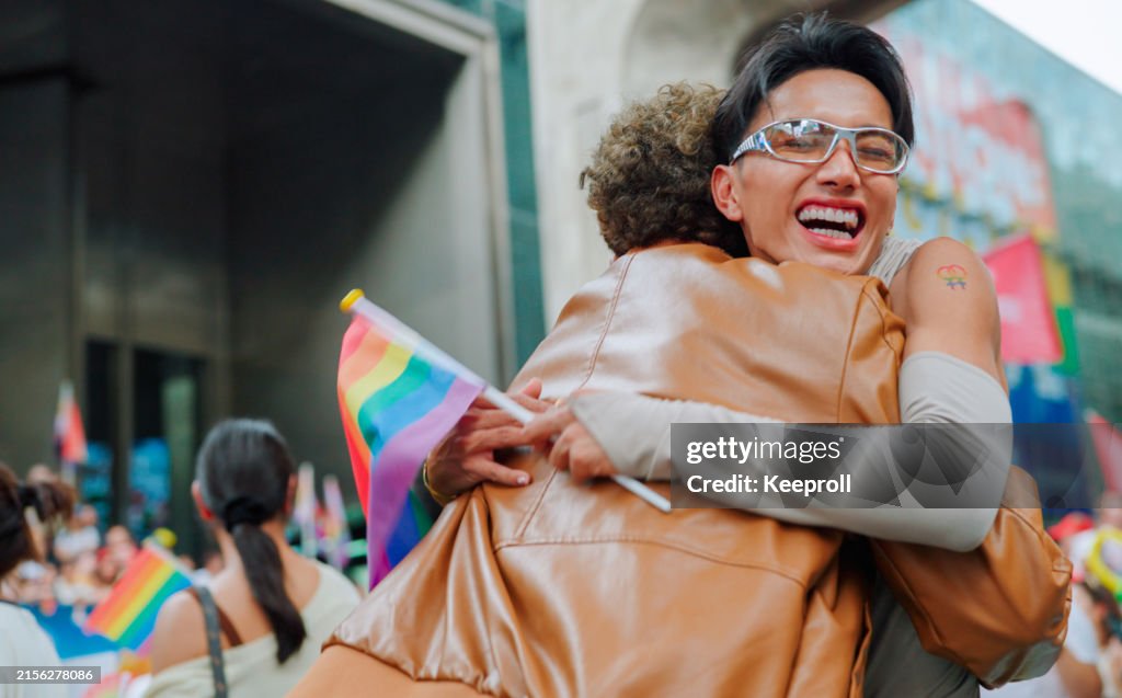 Two friend celebrating in pride parade