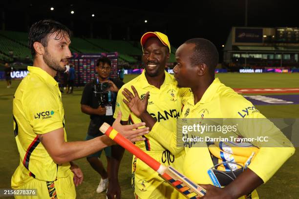 Riazat Ali Shah of Uganda congratulated teammates Brian Masaba and Kenneth Waiswa after winning for Uganda's first ever ICC World Cup victory in the...