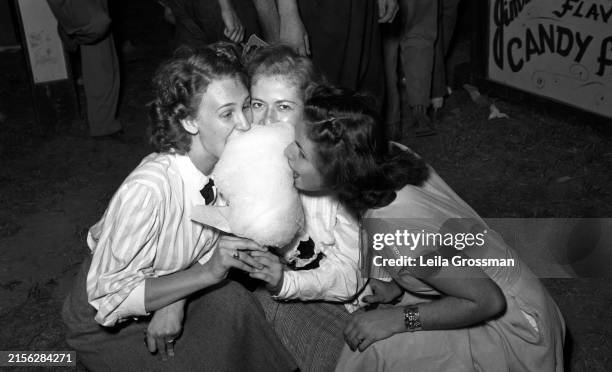 Three Ward Belmont students share cotton candy at the State Fair circa 1950 in Nashville, Tennessee.