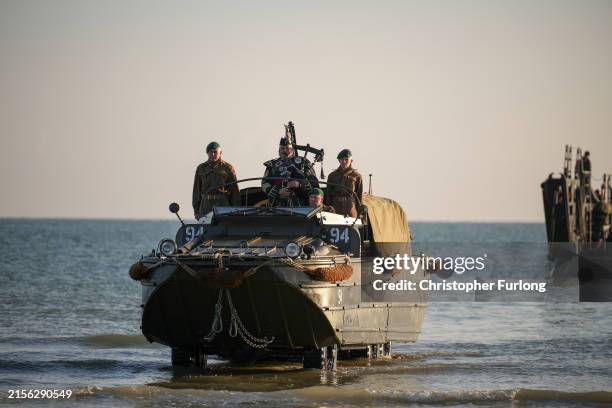 Pipe Major Trevor Macey-Lillie of the Scots Royal Artillery plays a lament as he arrives on Gold Beach in a WWII landing craft at 0726, the exact...