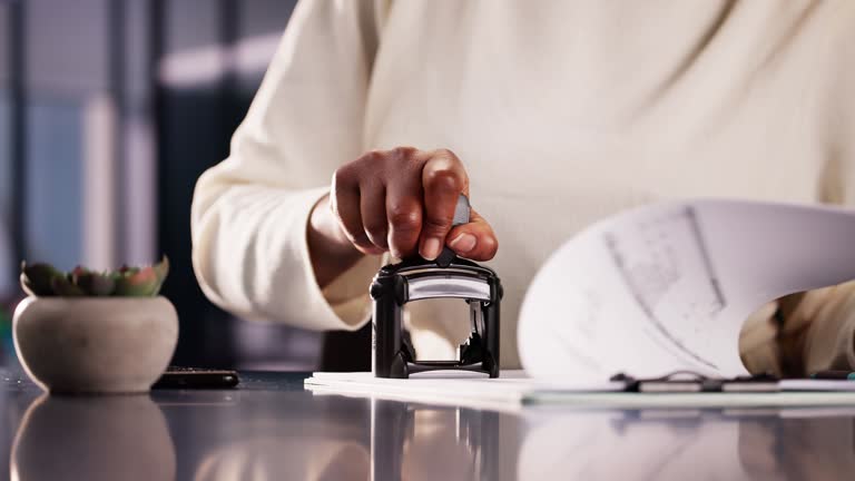 https://media.gettyimages.com/id/2156301190/video/businesswoman-notarizing-documents-with-stamp-in-office-legal-assistant-approving-contracts.jpg?b=1&s=640x640&k=20&c=NvIXzPytzYw87tz-kZDC3ud9GsiM09lCOYrPJMSPG34=