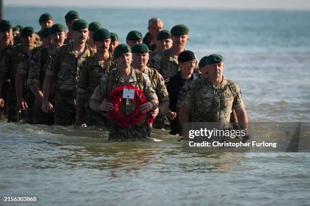 Royal Marines of 47 Commando land on Gold Beach to mark the 80th anniversary of the D-Day landings on June 06, 2024 in Asnelles, France. June 6th is...
