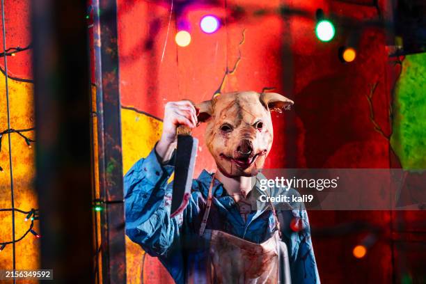 creepy character in halloween haunted house - man holding pig stock pictures, royalty-free photos & images