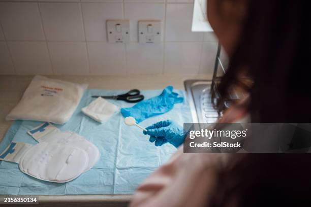 preparing her stoma bag equipment - colonoscopy bag stock pictures, royalty-free photos & images