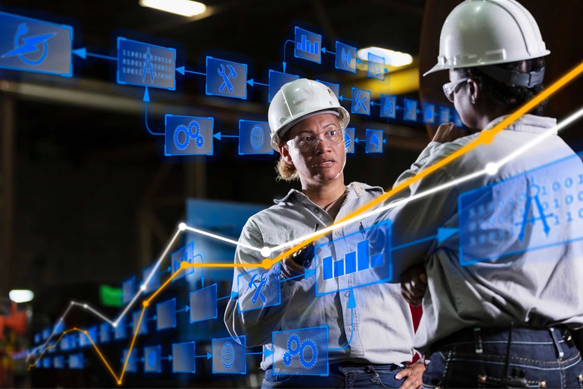 Two multiracial women engineers in warehouse conversing Two multiracial women engineers in warehouse conversing