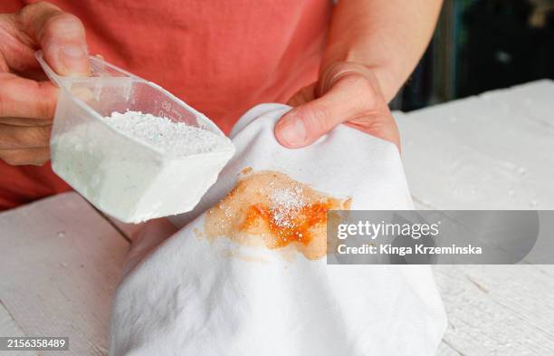 removing tomato stain from the fabric - stained stock pictures, royalty-free photos & images