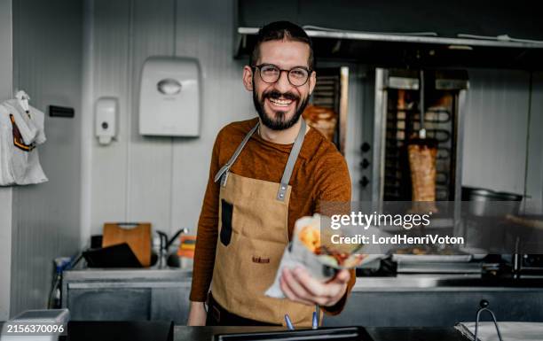 male worker in a fast food shop - doner kebab fast food stock pictures, royalty-free photos & images