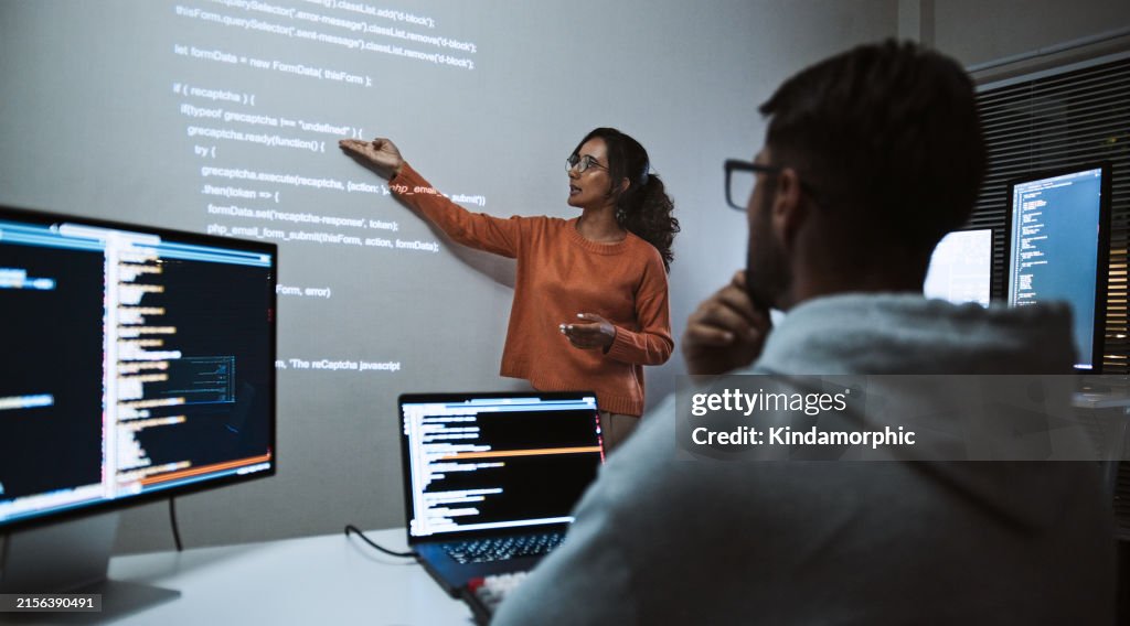 Hispanic Latin American software engineer developer use laptop computer program coding, projection screen presentation. Programming language development, business technology, night work people concept