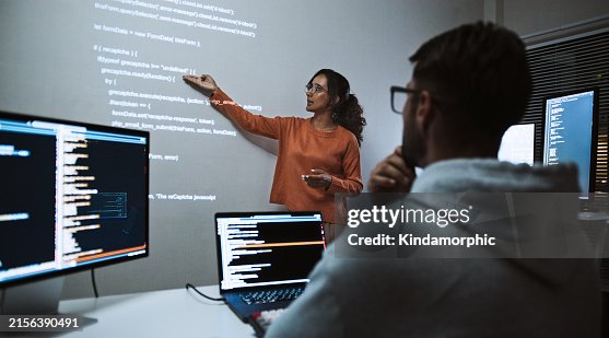 Hispanic Latin American software engineer developer use laptop computer program coding, projection screen presentation. Programming language development, business technology, night work people concept Hispanic Latin American software engineer developer use laptop computer program coding, projection screen presentation. Programming language development, business technology, night work people concept