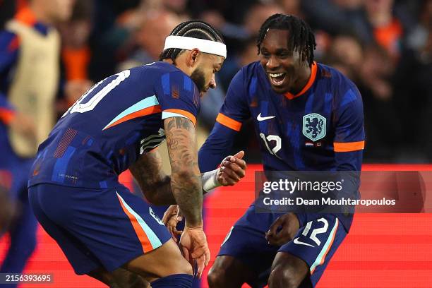 Memphis Depay of the Netherlands celebrates scoring the opening goal with team mate Jeremie Frimpong during the international friendly match between...