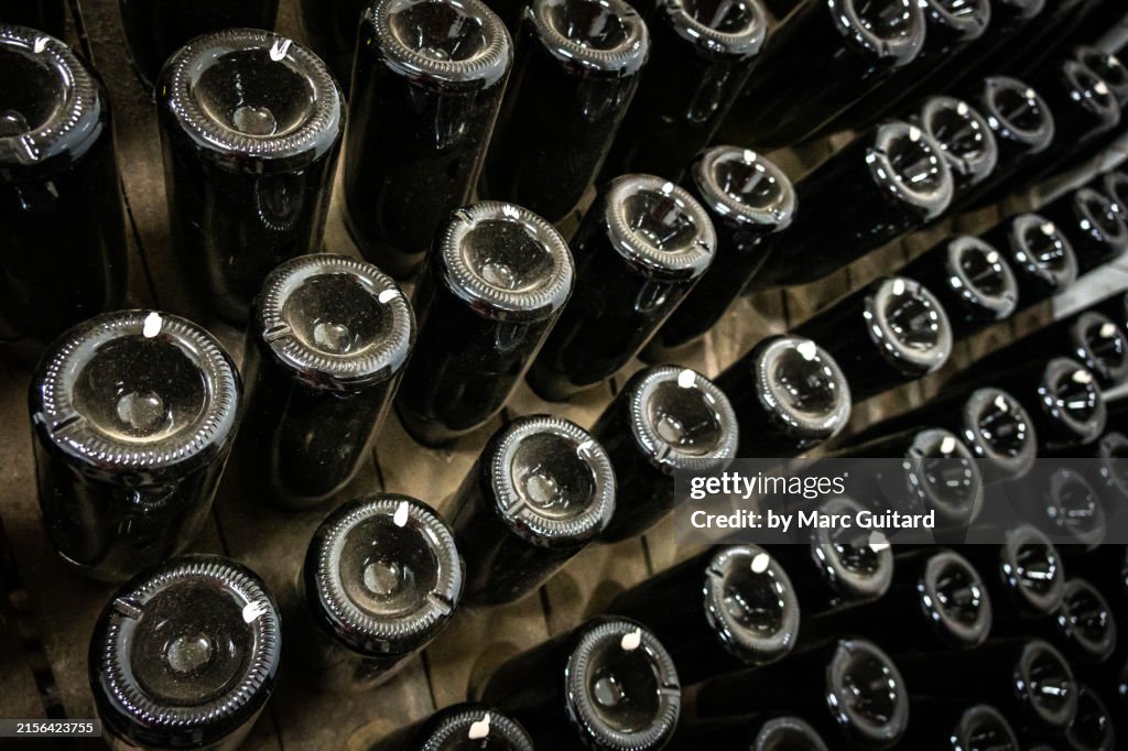 Tilted wine bottles in a cellar at a winery near Chisinau, Moldova