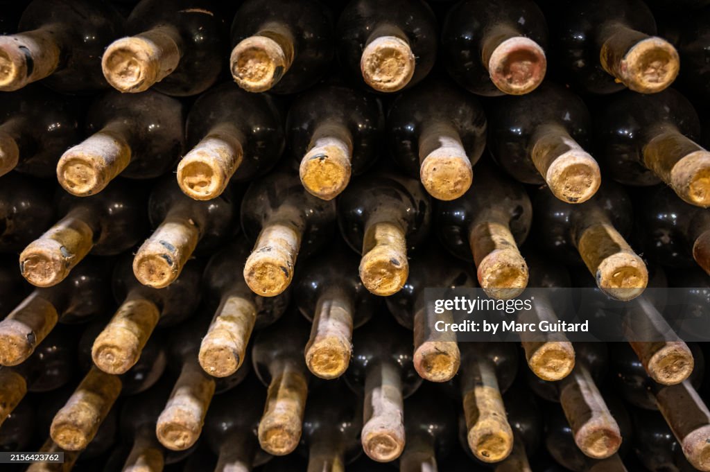 Old bottles of wine stored on their sides in a wine cellar near Chisinau, Moldova