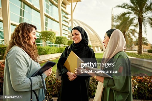 Saudi women talking to each other in university campus Saudi women talking to each other in university campus