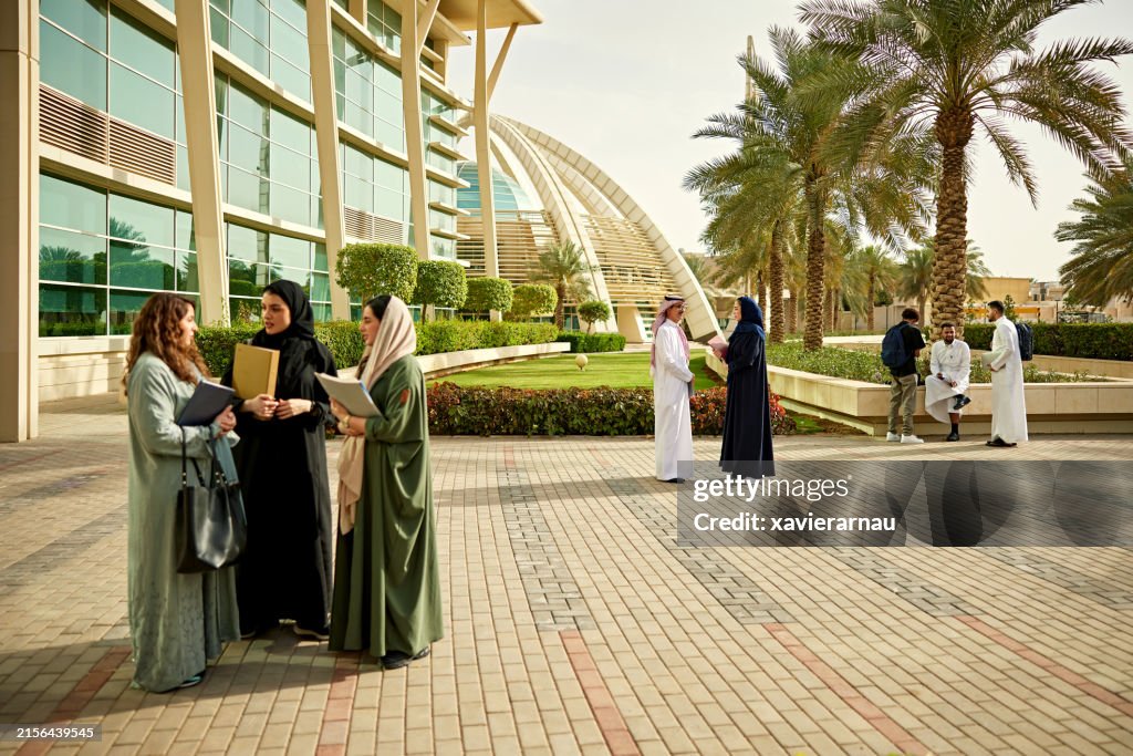 Teachers and students discussing in university campus