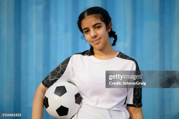 teenage female player with soccer ball against wall - girl tilting head stock pictures, royalty-free photos & images
