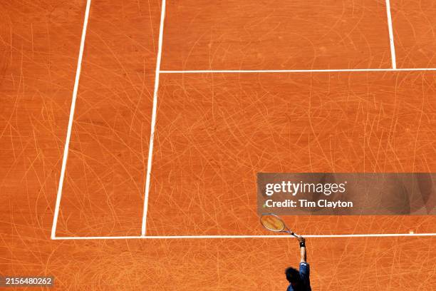 June 07: Patterns on the clay court surface caused by the wheels of the wheelchairs as Takuya Miki of Japan plays a shot while playing with teammate...