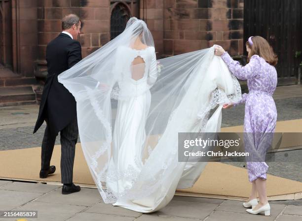 The bridal veil of Olivia Henson blows in the wind as she arrives for her wedding to Hugh Grosvenor, Duke of Westminster at Chester Cathedral on June...