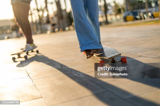 diverse friends enjoy longboarding together - skateboarding stock pictures, royalty-free photos & images