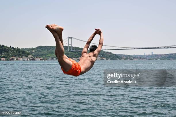 Man jumps into the sea to cool himself off during hot weather in Istanbul, Turkiye on June 11, 2024.