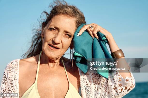 old woman at the beach during a heatwave - climate change - hyperthermia stock pictures, royalty-free photos & images