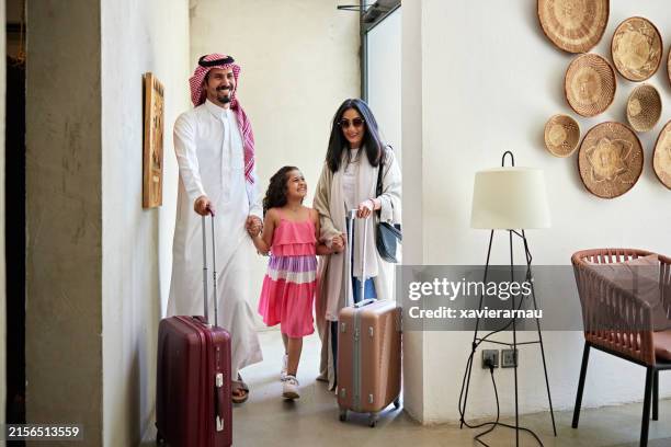 happy middle eastern family holding hands in villa - saudi arabia people stock pictures, royalty-free photos & images
