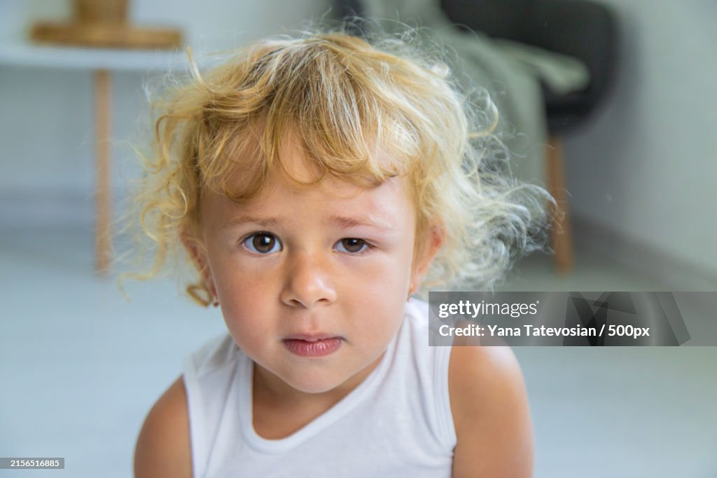 Close-up portrait of cute girl at home