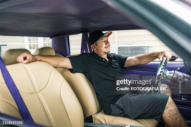 mid adult latino male business owner at auto body paint shop - custom car driver stock pictures, royalty-free photos & images
