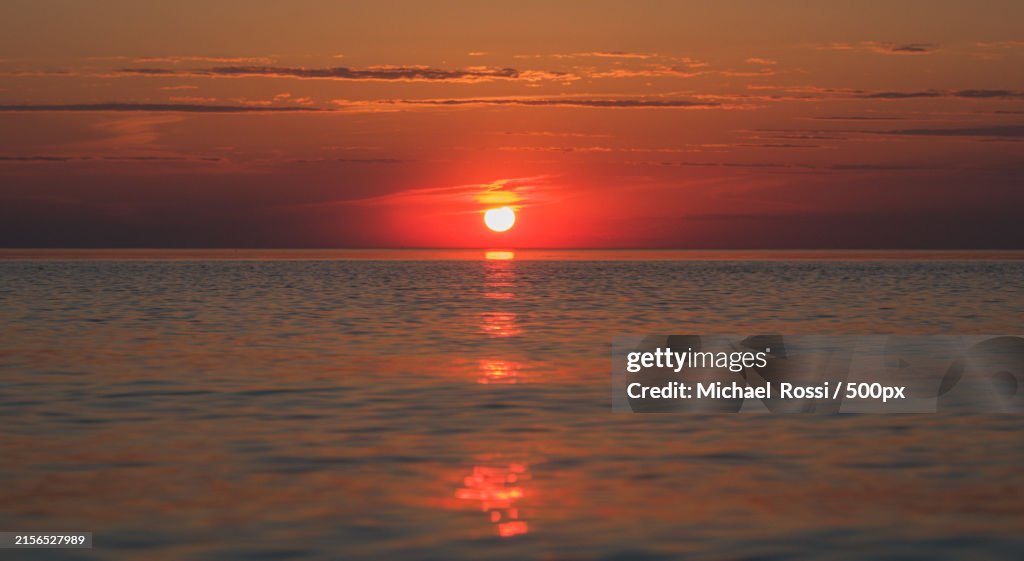 Scenic view of sea against orange sky,Saugatuck,Michigan,United States,USA