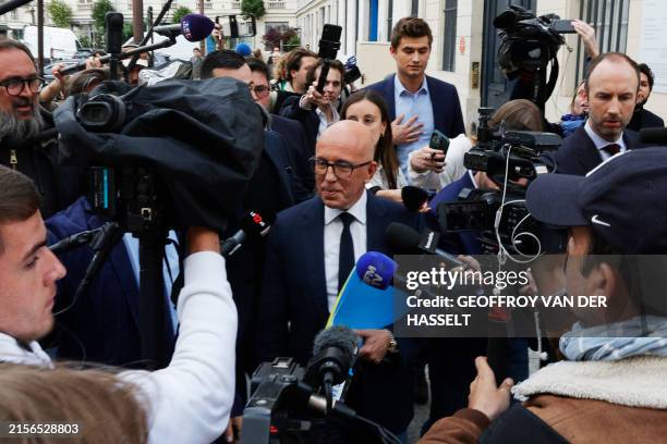 Leader of Les Republicains party Eric Ciotti is surrounded by media as he walks outside the National Assembly in Paris on June 11, 2024 following the...