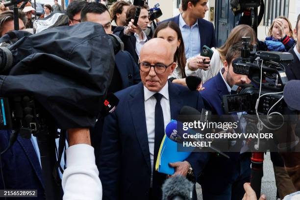 Leader of Les Republicains party Eric Ciotti is surrounded by media as he walks outside the National Assembly in Paris on June 11, 2024 following the...