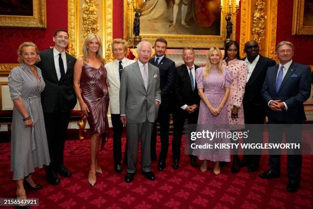 Britain's King Charles III poses with the presenters of the inaugural King's Foundation charity awards at St James' Palace, in central London, on...