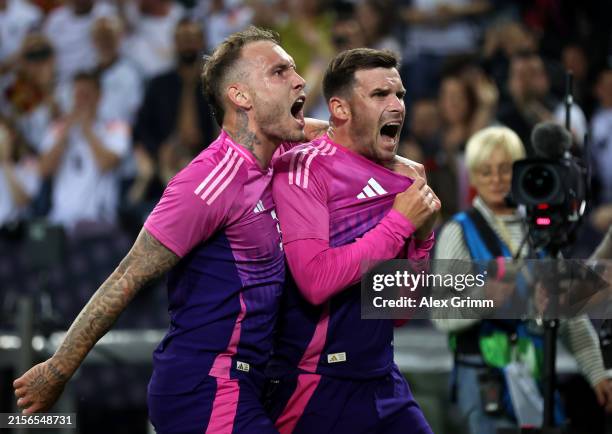 Pascal Gross of Germany celebrates scoring his team's second goal with teammate David Raum during the international friendly match between Germany...