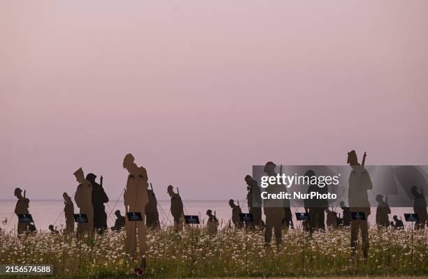 An art installation featuring 1,475 upcycled giant soldier silhouettes by Standing with Giants symbolizing the British-commanded fatalities on June 6...