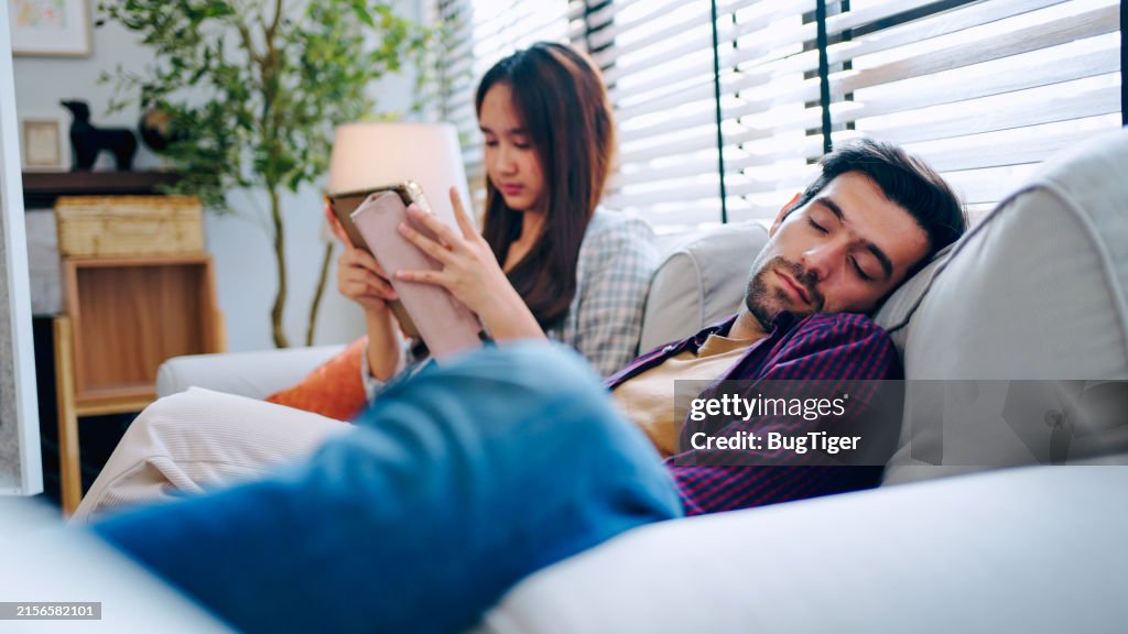 Relaxed young man sleeping leaning on cozy sofa.