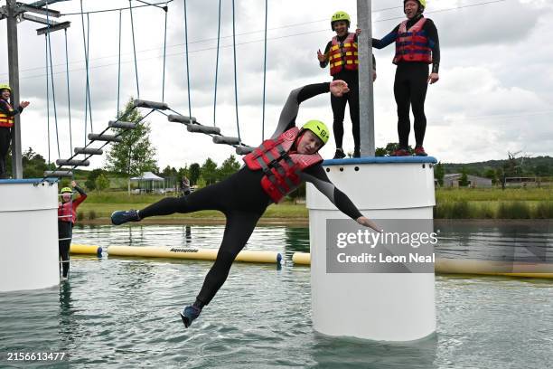 Leader of the Liberal Democrats Ed Davey falls into the water during a visit to the Spot On Wake aqua jungle at Wootton Park on June 12, 2024 in...