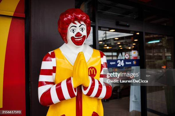 Ronald McDonald poses with a traditional Thai "wai" greeting at the entrance to a McDonald's restaurant in Central Bangkok on June 08, 2024 in...