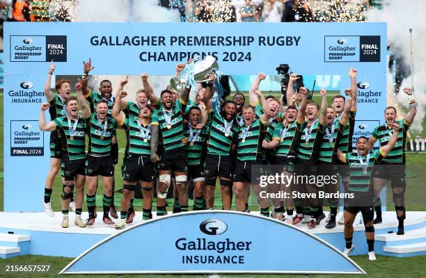 Courtney Lawes and Lewis Ludlam of Northampton Saints lift the Gallagher Premiership Rugby Trophy after their team's victory in the Gallagher...