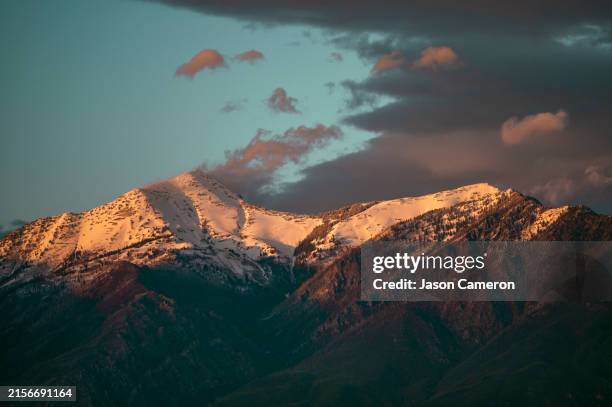 sunset light on a mountain with clouds - bluffdale utah stock pictures, royalty-free photos & images