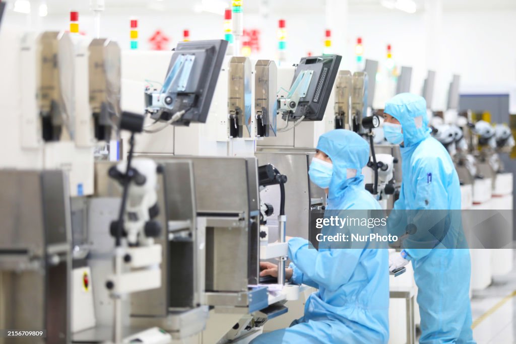 Power Device Manufacturing Workers are checking the production of electronic chips at a... News ...